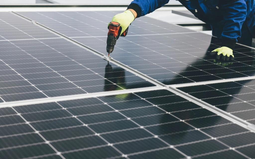 rooftop solar panel repair service technician with drill