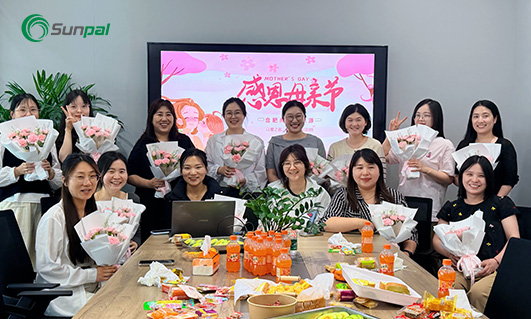 Sunpal Solar female employees holding bouquets at a Mother's Day tea gathering.