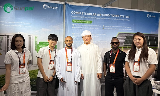 Sunpal Solar team members pose with Middle Eastern clients in front of solar and energy storage solution display boards at Middle East Energy 2026 in Dubai.
